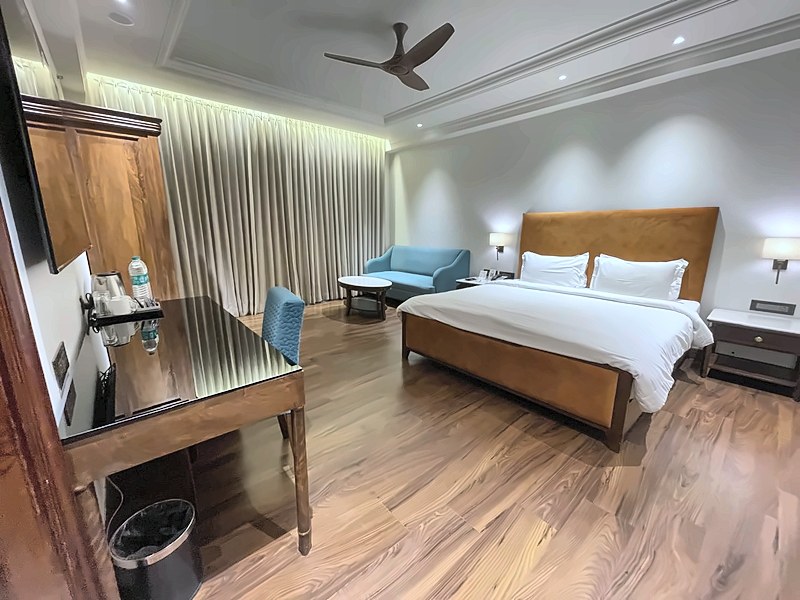 Deluxe Room with king bed, work desk and curtains at Hotel Gold Palace & Resorts, Jaipur